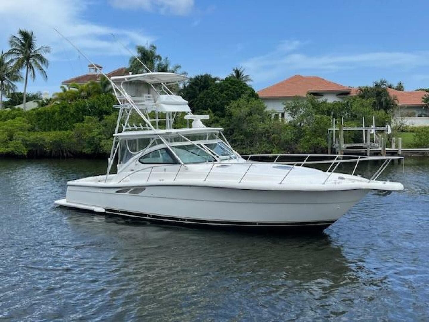 2003 Tiara Yachts 3800 Open cruising on a calm waterway with lush greenery.