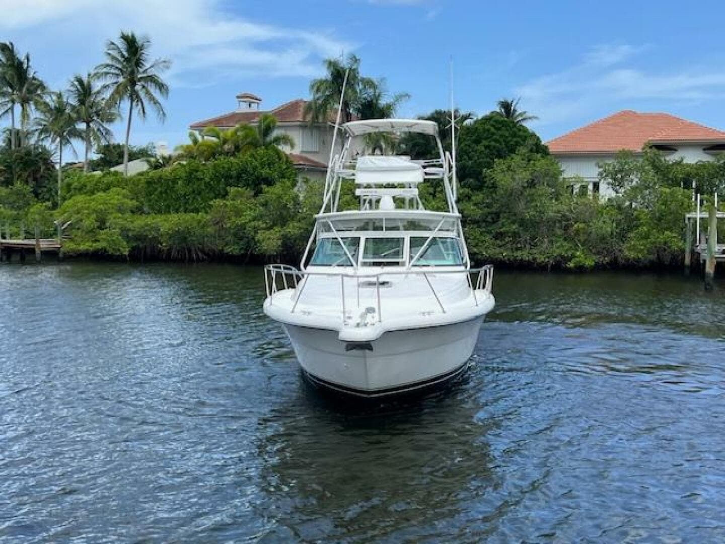 2003 Tiara Yachts 3800 Open on water, surrounded by tropical scenery.