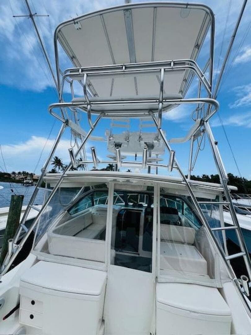 2003 Tiara Yachts 3800 Open with tower, docked under blue sky.