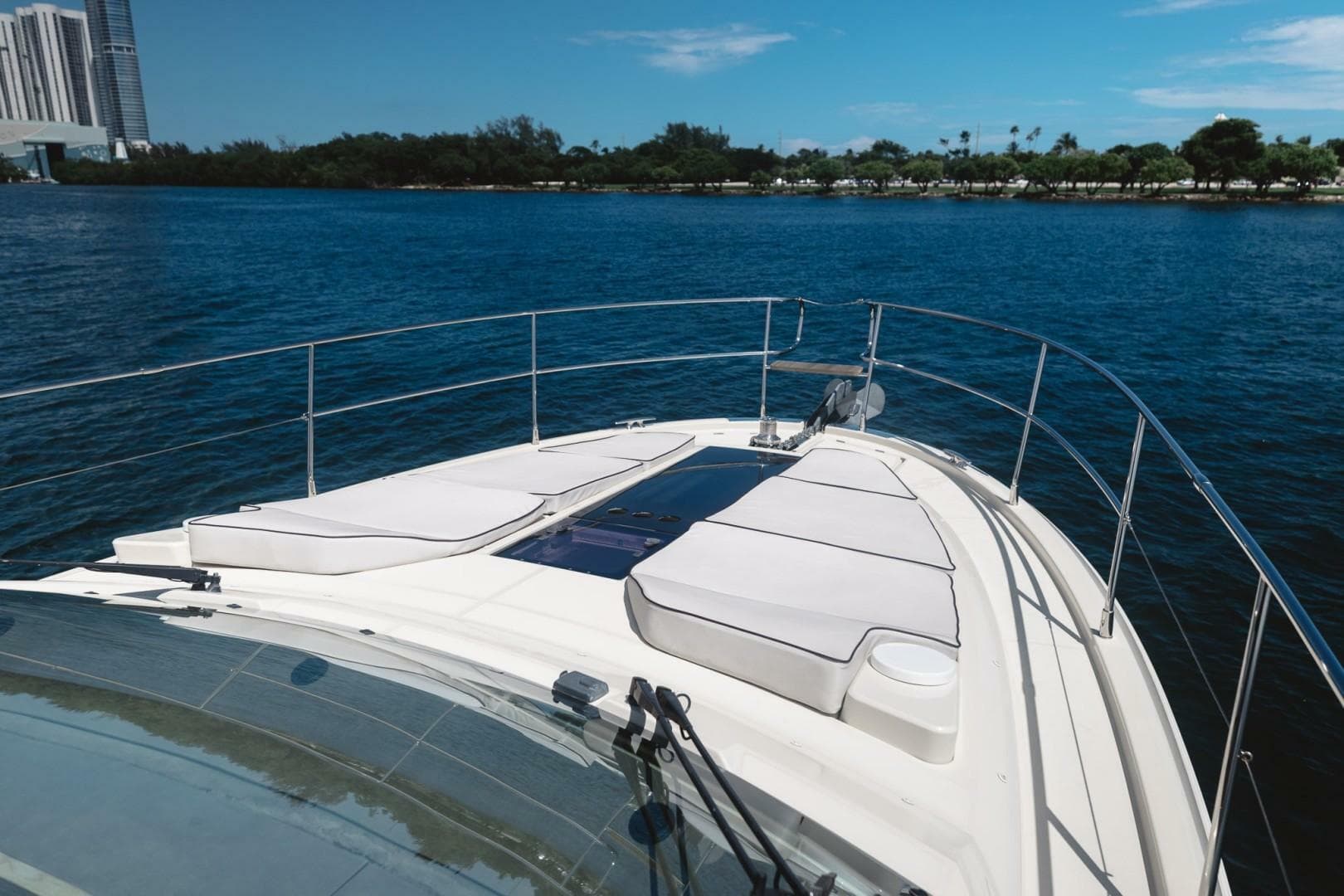 2015 Beneteau Monte Carlo 5 yacht deck with sun loungers on calm water.