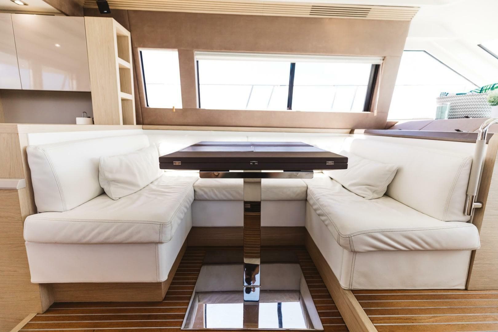 Luxurious interior of 2015 Beneteau Monte Carlo 5 yacht with elegant seating and table.