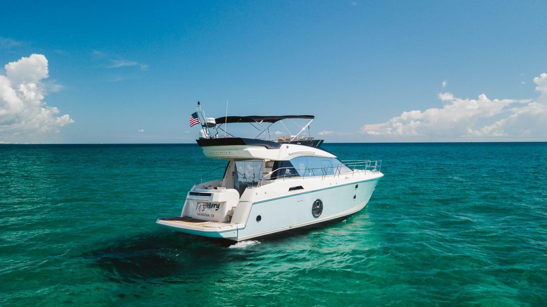 2015 Beneteau Monte Carlo 5 yacht cruising on clear blue ocean waters.