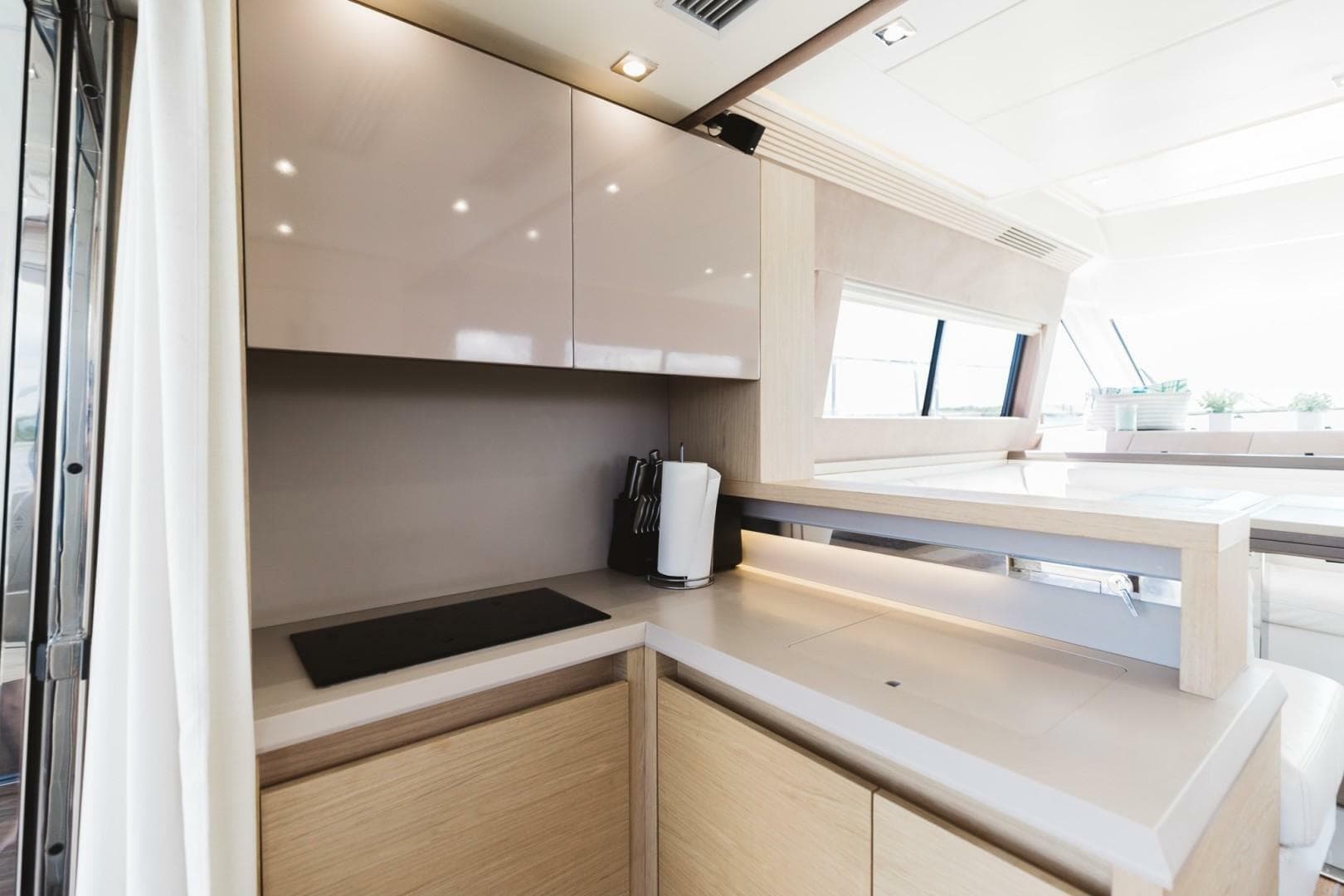 Modern kitchen interior on 2015 Beneteau Monte Carlo 5 yacht, featuring sleek cabinetry and appliances.