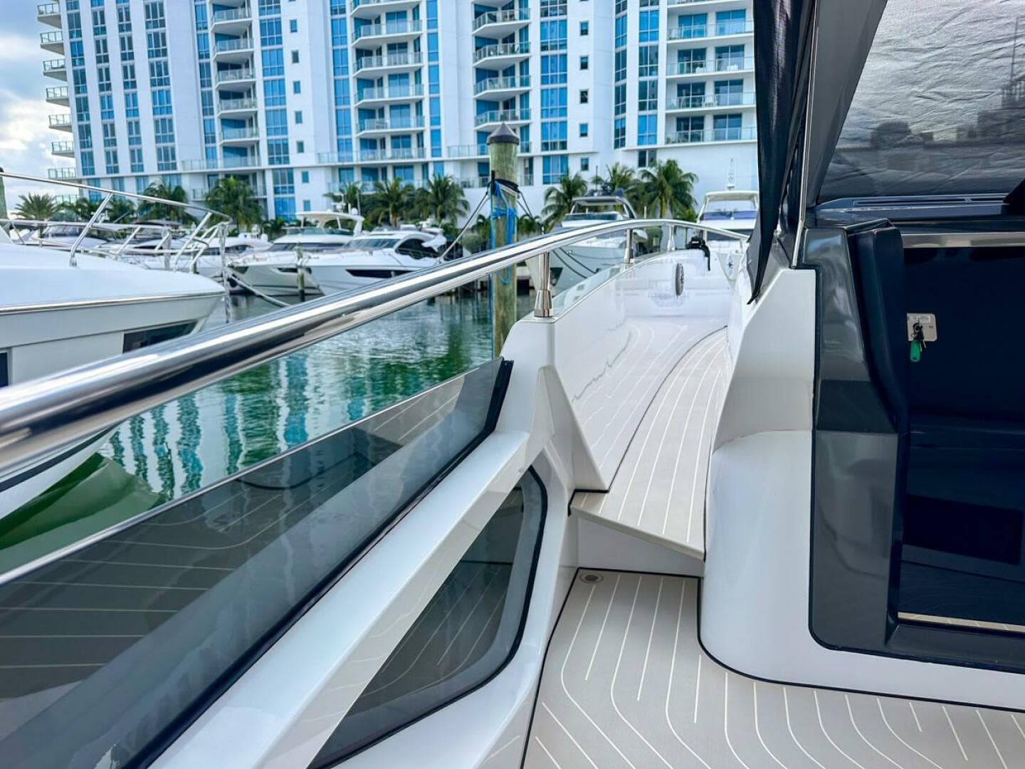 2023 Azimut Verve 47 yacht docked near modern waterfront buildings.