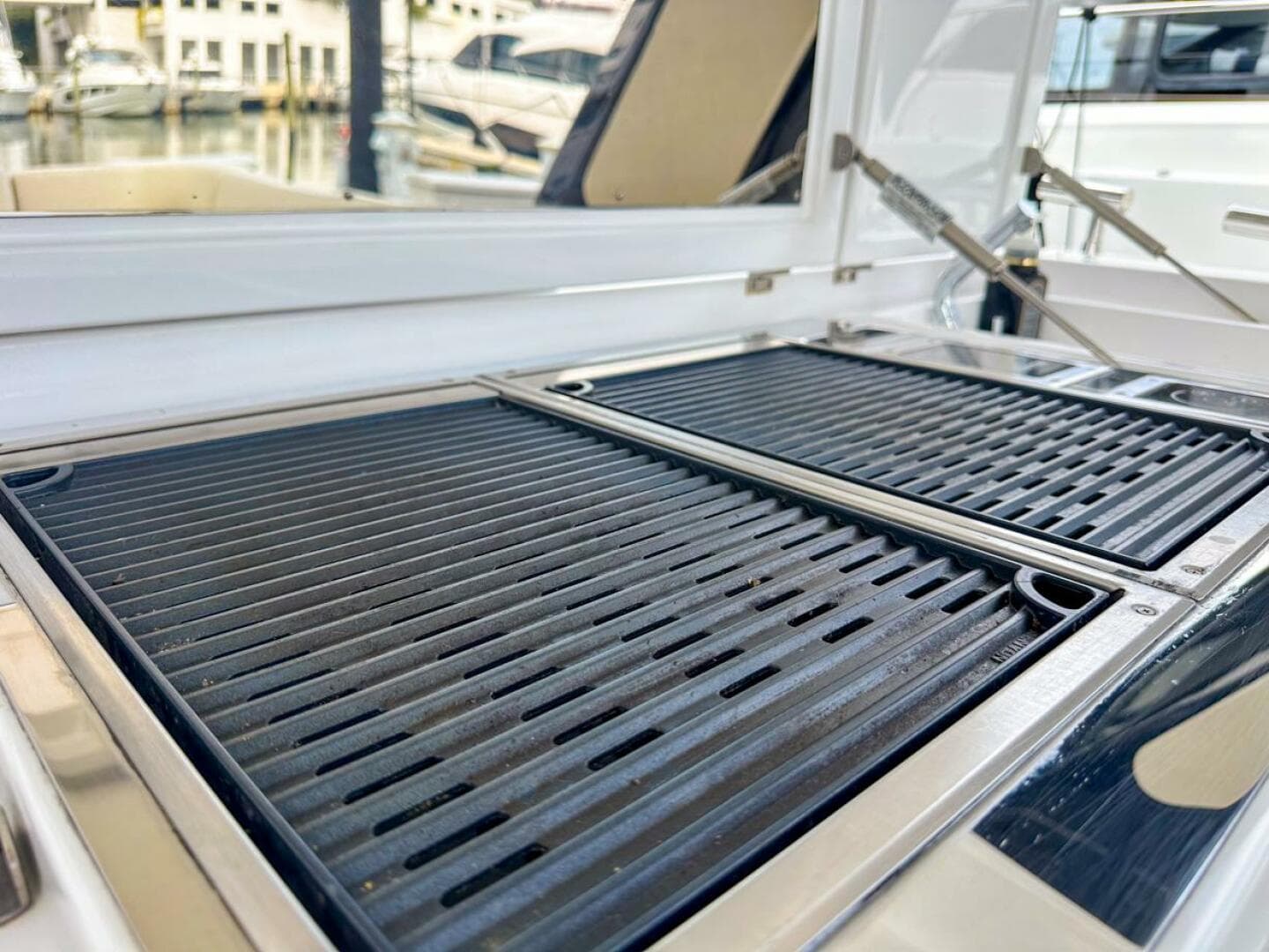 Outdoor grill on 2023 Azimut Verve 47 yacht, docked at marina.