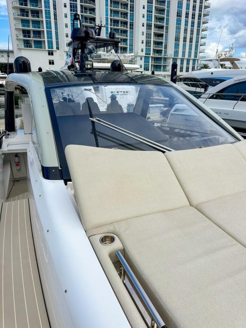 2023 Azimut Verve 47 luxury yacht docked near modern buildings.