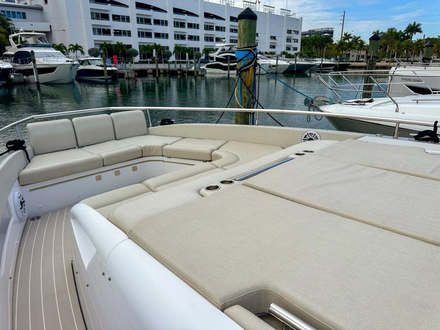 2023 Azimut Verve 47 yacht with spacious deck seating in a marina.