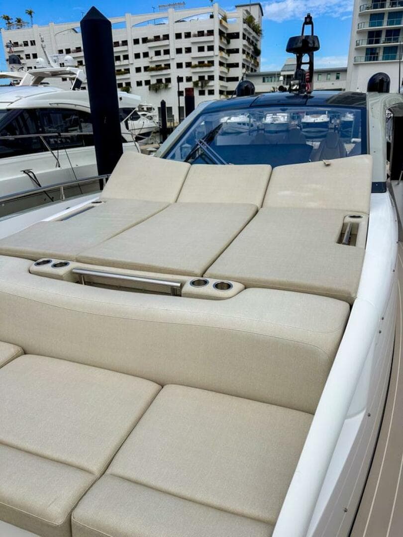 2023 Azimut Verve 47 luxury yacht with spacious sunbathing deck in marina setting.