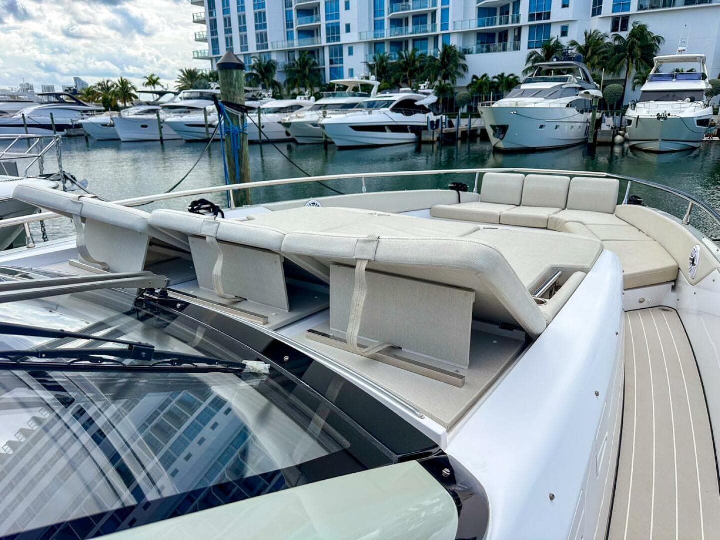 2023 Azimut Verve 47 yacht with luxurious deck seating in a marina setting.