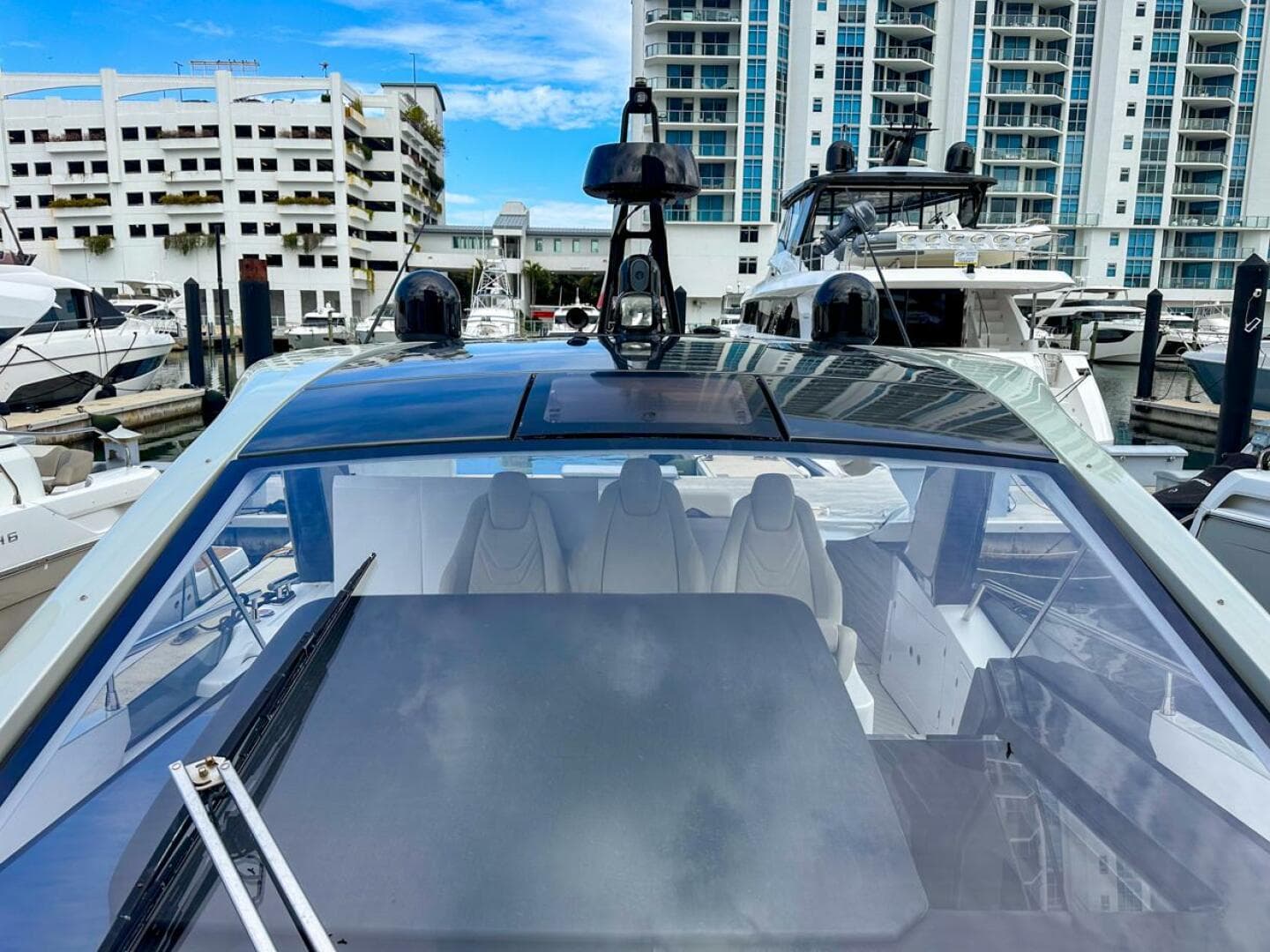 2023 Azimut Verve 47 yacht docked at marina with modern design and cityscape background.