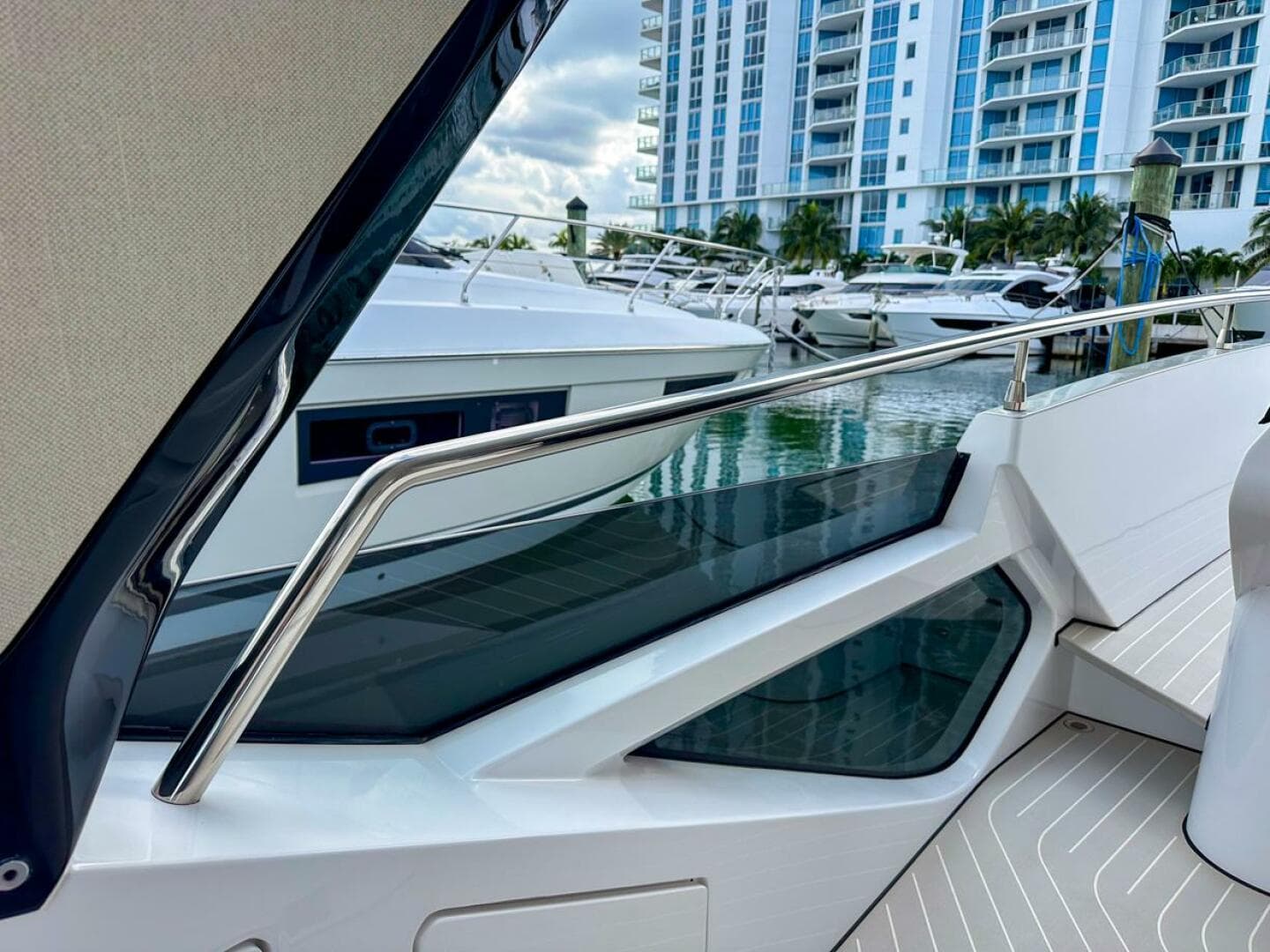 2023 Azimut Verve 47 yacht docked near modern waterfront buildings.