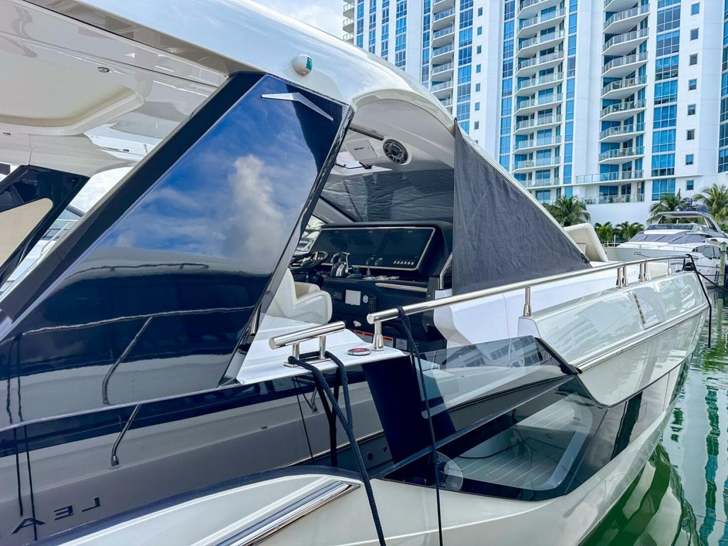 2023 Azimut Verve 47 yacht docked near modern high-rise buildings.