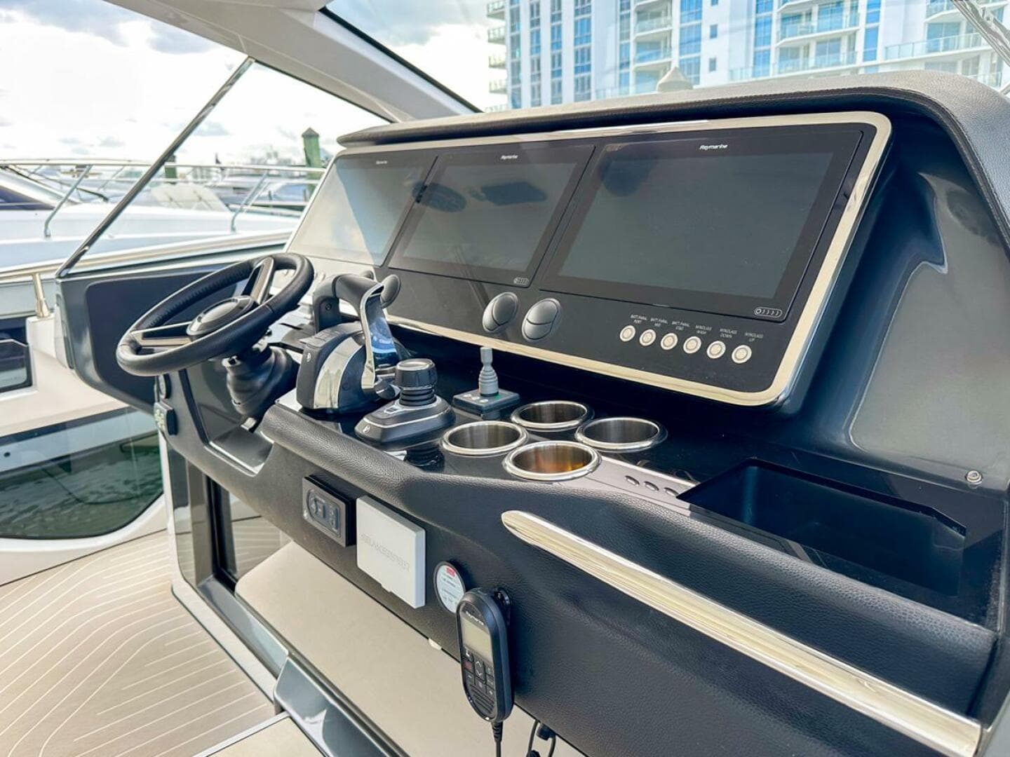 Cockpit of 2023 Azimut Verve 47 yacht with modern navigation displays and controls.