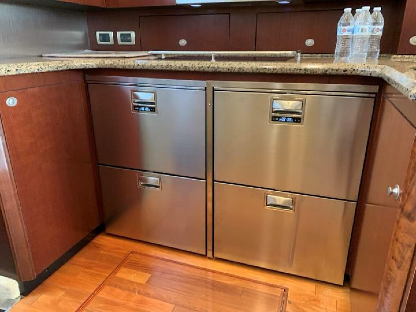 Modern kitchen area in 2006 Sea Ray 52 Sedan Bridge yacht with stainless steel appliances.