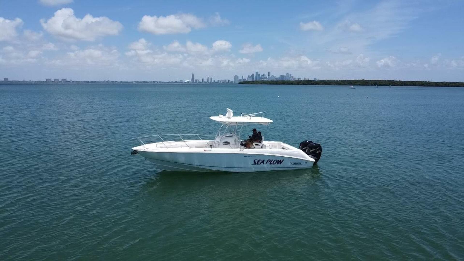 2008 Boston Whaler 320 Outrage boat named Sea Plow on calm waters.