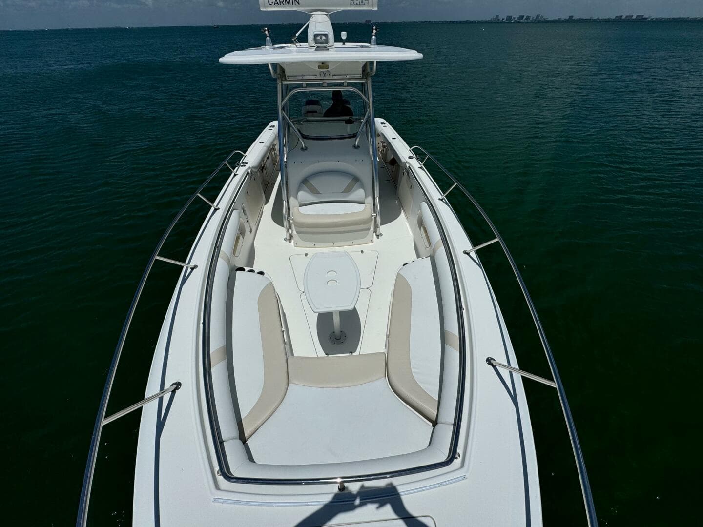 2008 Boston Whaler 320 Outrage boat on calm water, aerial view.