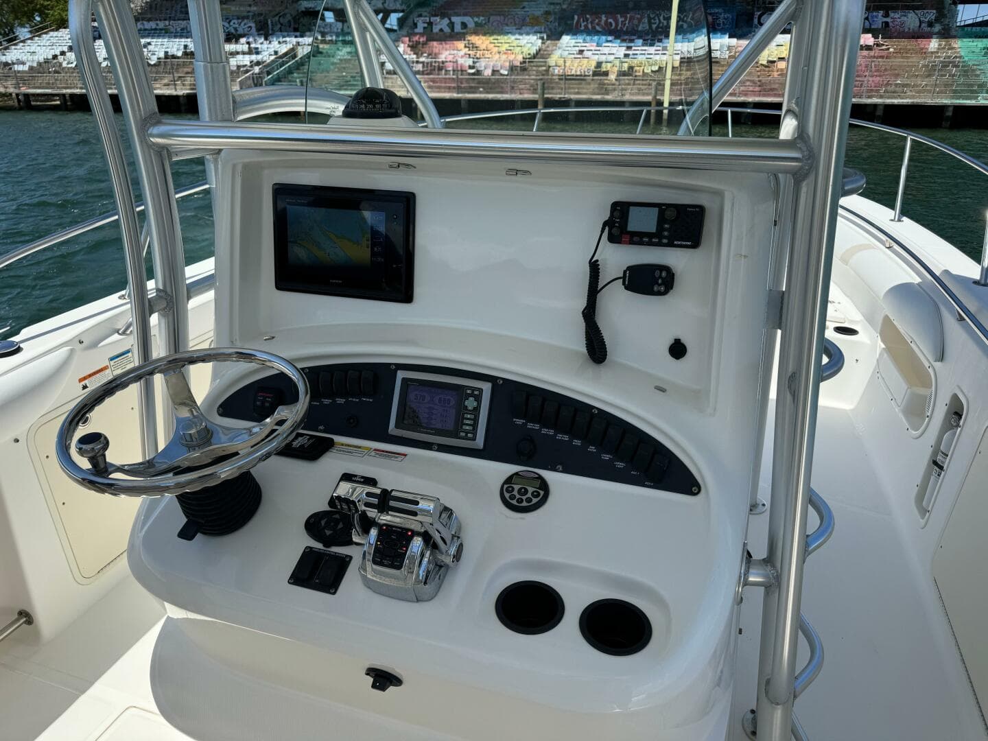 2008 Boston Whaler 320 Outrage helm with navigation equipment and steering wheel.