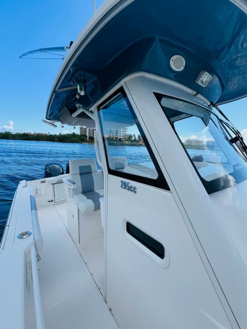 2012 Everglades 295 Center Console boat on calm water, side view.