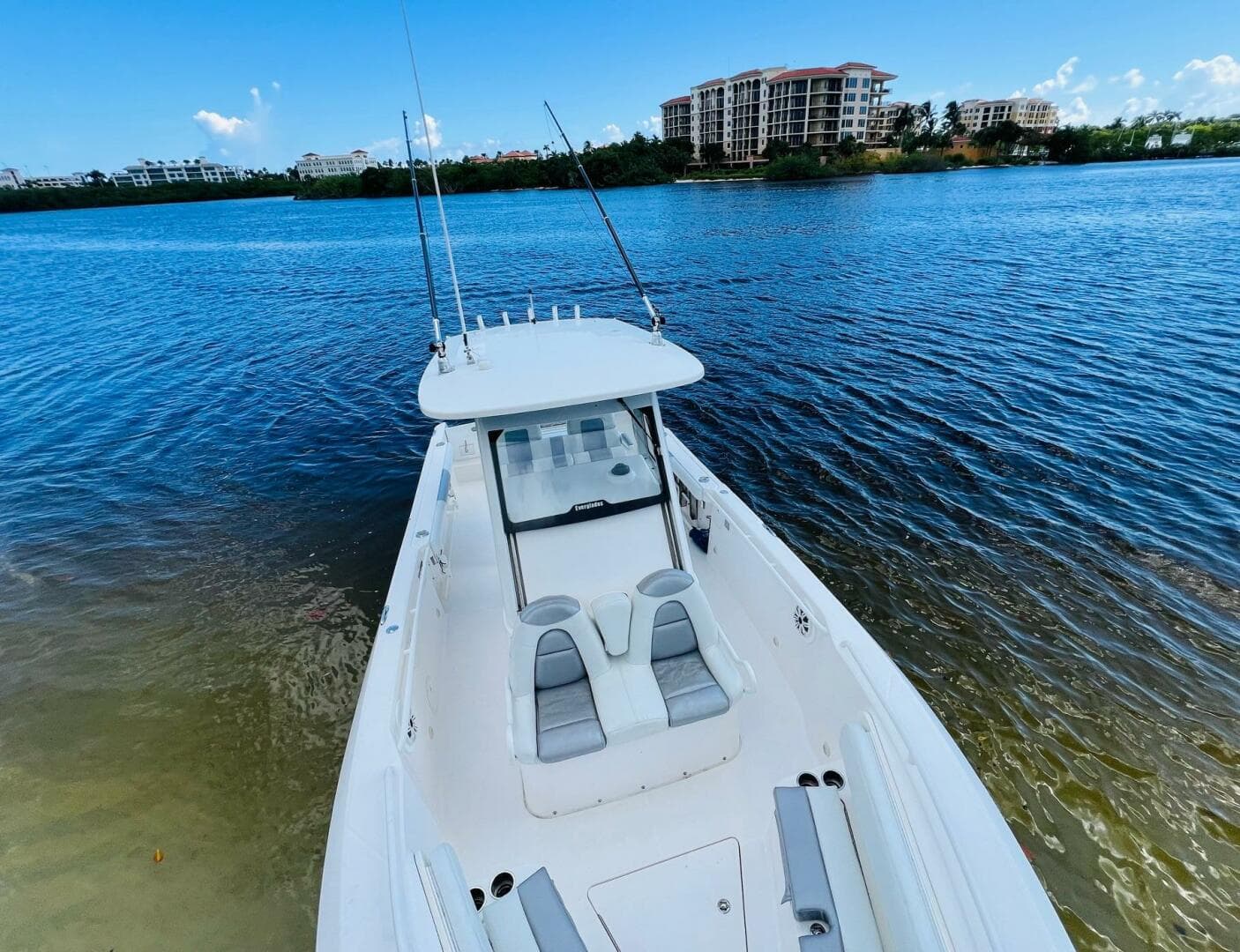 2012 Everglades 295 Center Console boat on calm water with scenic background.