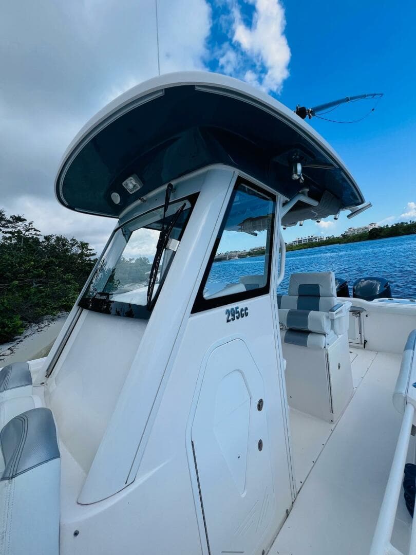 2012 Everglades 295 Center Console boat on water, featuring sleek design and spacious seating.