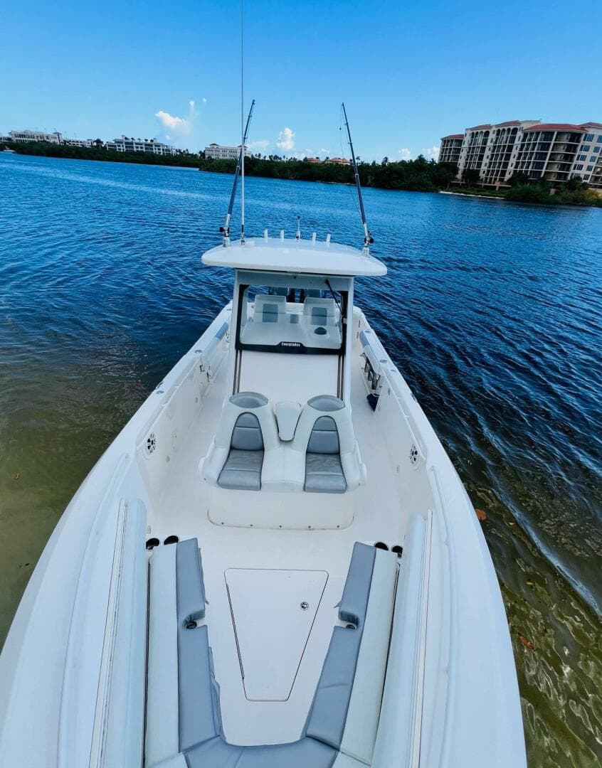 2012 Everglades 295 Center Console boat on calm water, clear sky background.