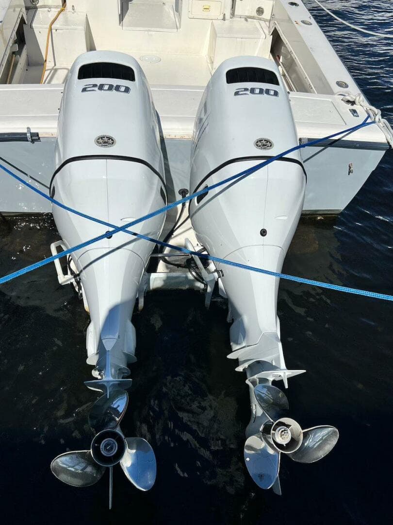 Twin outboard motors on 1988 Grady-White 25 Sailfish boat, docked on water.