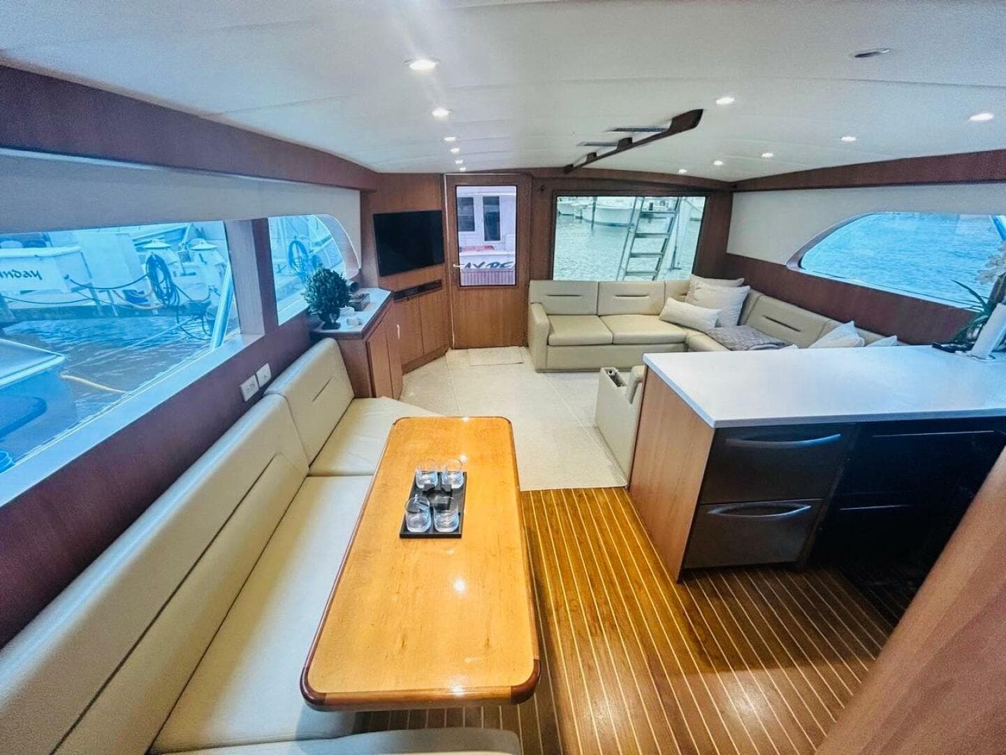 Luxurious interior of a 1988 Bertram 54' yacht with elegant seating and wood finishes.
