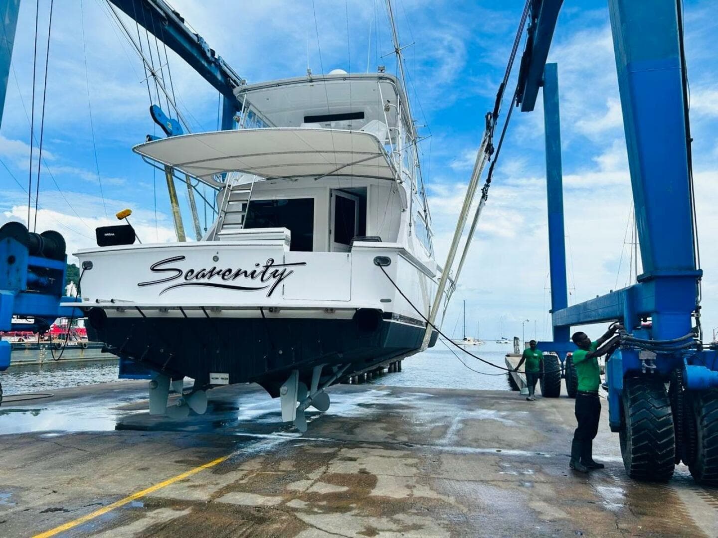 1988 Bertram 54' yacht "Sea-renity" being lifted at a marina.