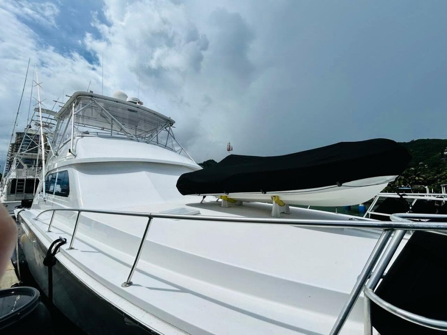 1988 Bertram 54' yacht docked under cloudy sky.