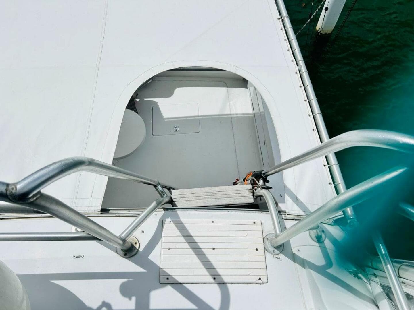 View of 1988 Bertram 54' yacht deck with metal railings and hatch.