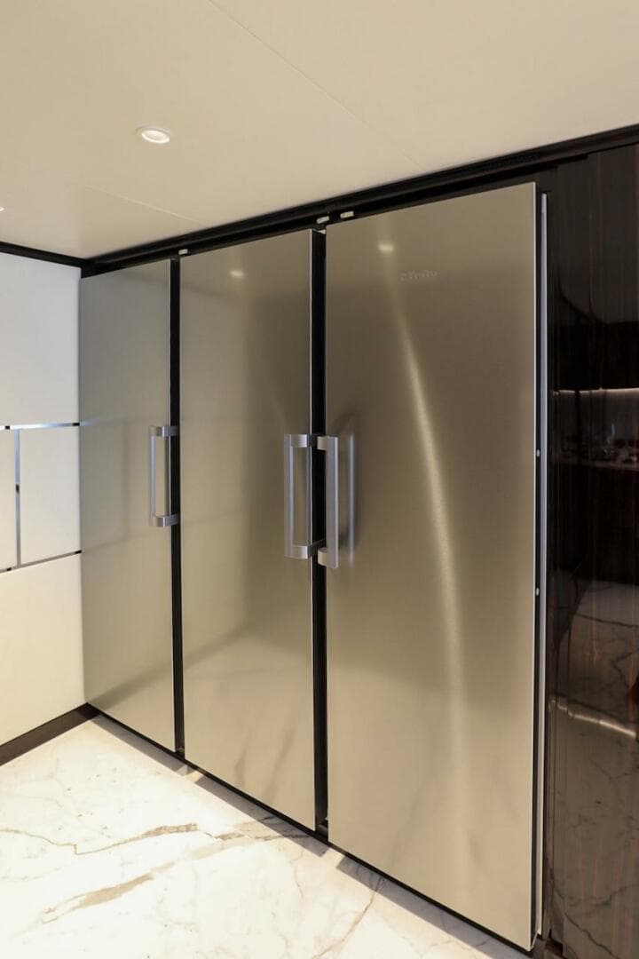 Sleek 2025 Majesty 120 yacht interior with modern stainless steel appliances.