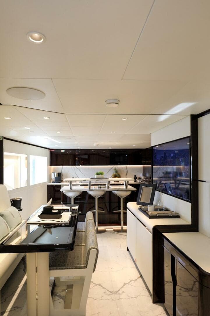 Luxurious interior of 2025 Majesty 120 yacht with modern dining and lounge area.