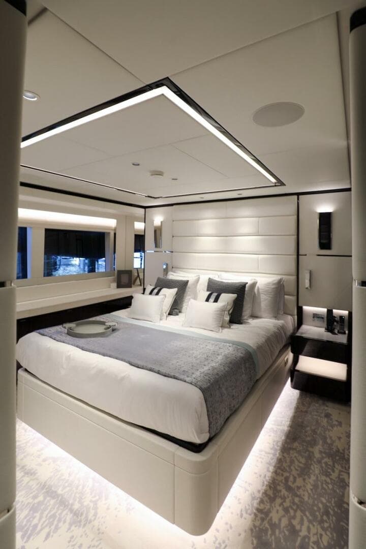 Luxurious bedroom interior on 2025 Majesty 120 yacht, featuring modern design and elegant lighting.