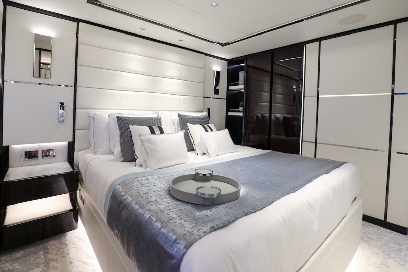Luxurious bedroom interior on 2025 Majesty 120 yacht, featuring elegant bedding and modern design.