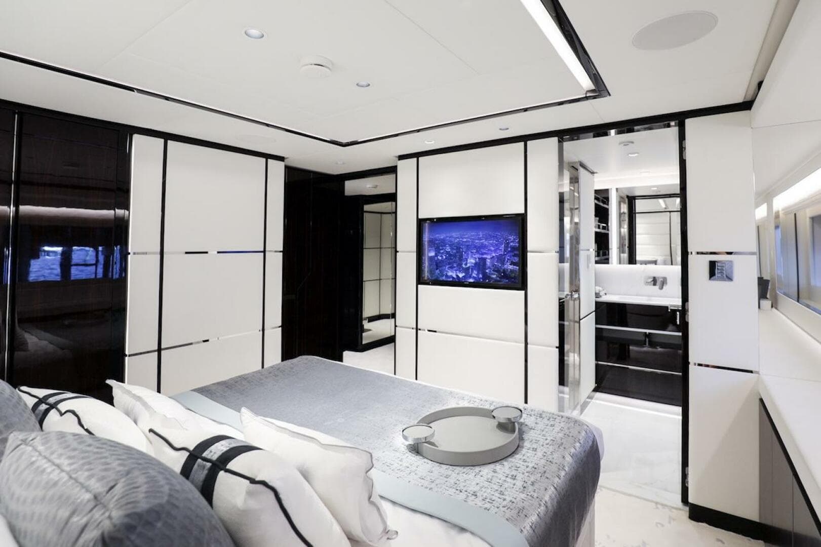 Luxurious interior of 2025 Majesty 120 yacht, featuring modern bedroom and ensuite bathroom.