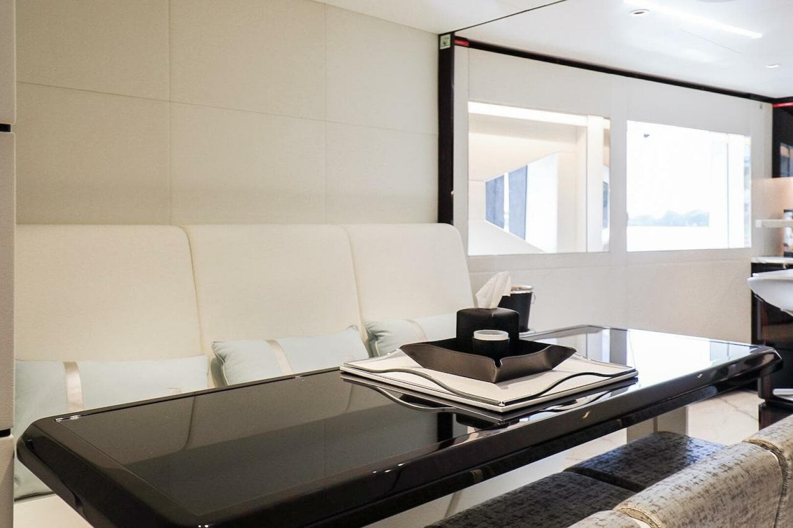 Luxurious interior of 2025 Majesty 120 yacht with sleek dining area and modern decor.