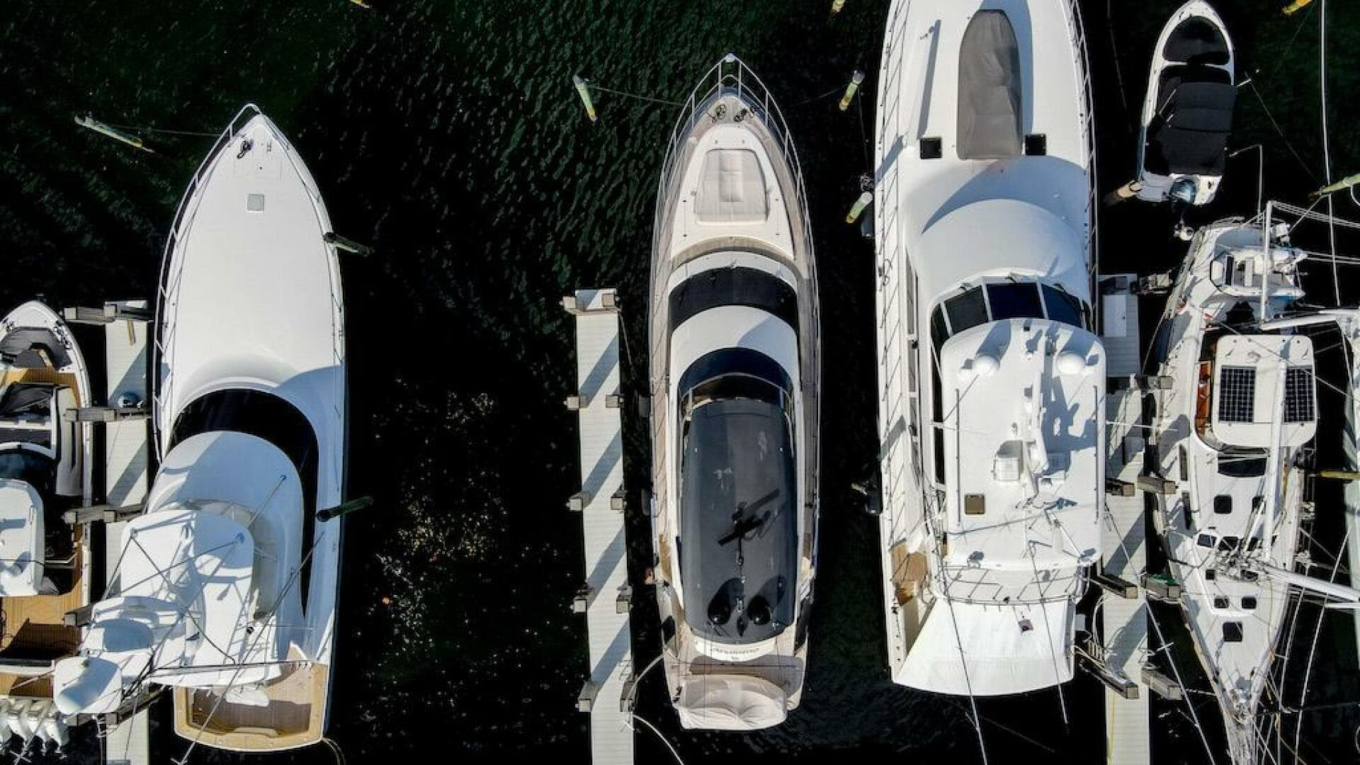Aerial view of 2016 Marquis 660 Sport Yacht docked among other boats.