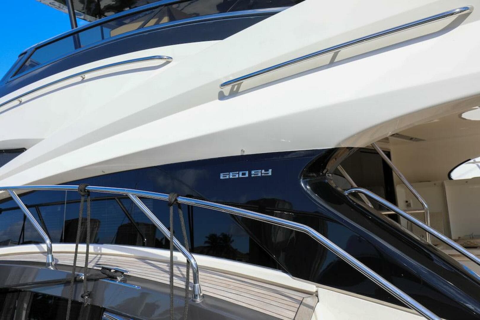 2016 Marquis 660 Sport Yacht, sleek design with polished railings and modern aesthetics.