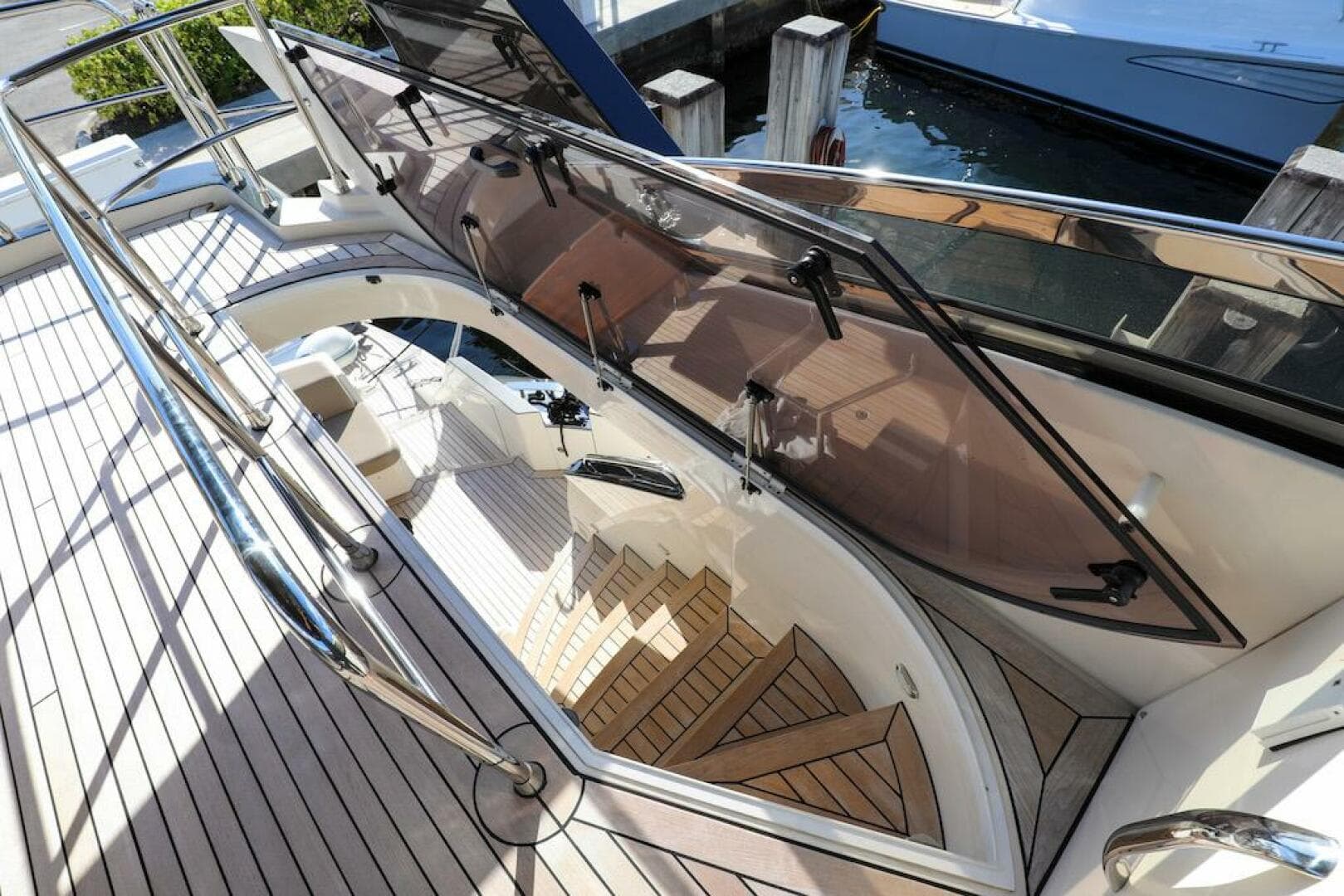 2016 Marquis 660 Sport Yacht with elegant deck and staircase, docked at marina.