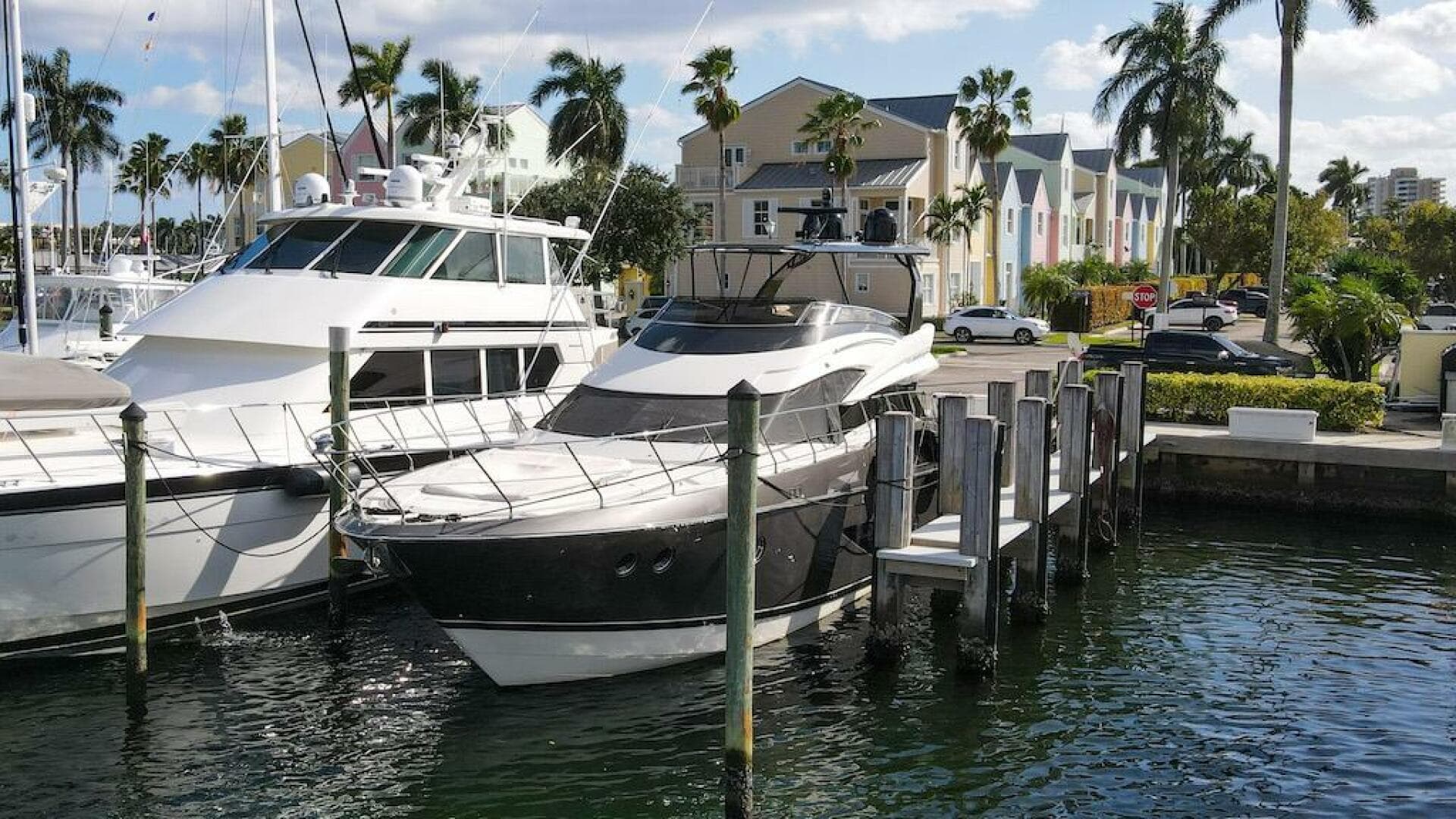 2016 Marquis 660 Sport Yacht docked in a sunny marina.