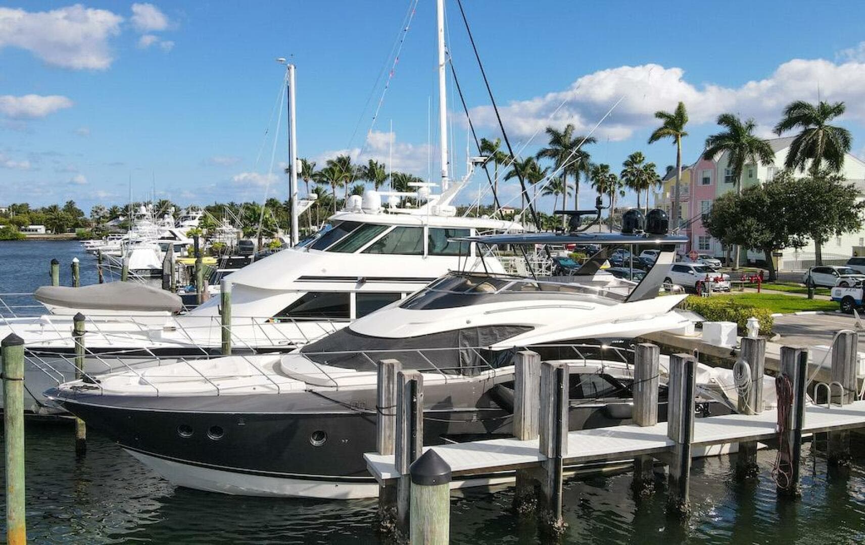 2016 Marquis 660 Sport Yacht docked in a sunny marina.