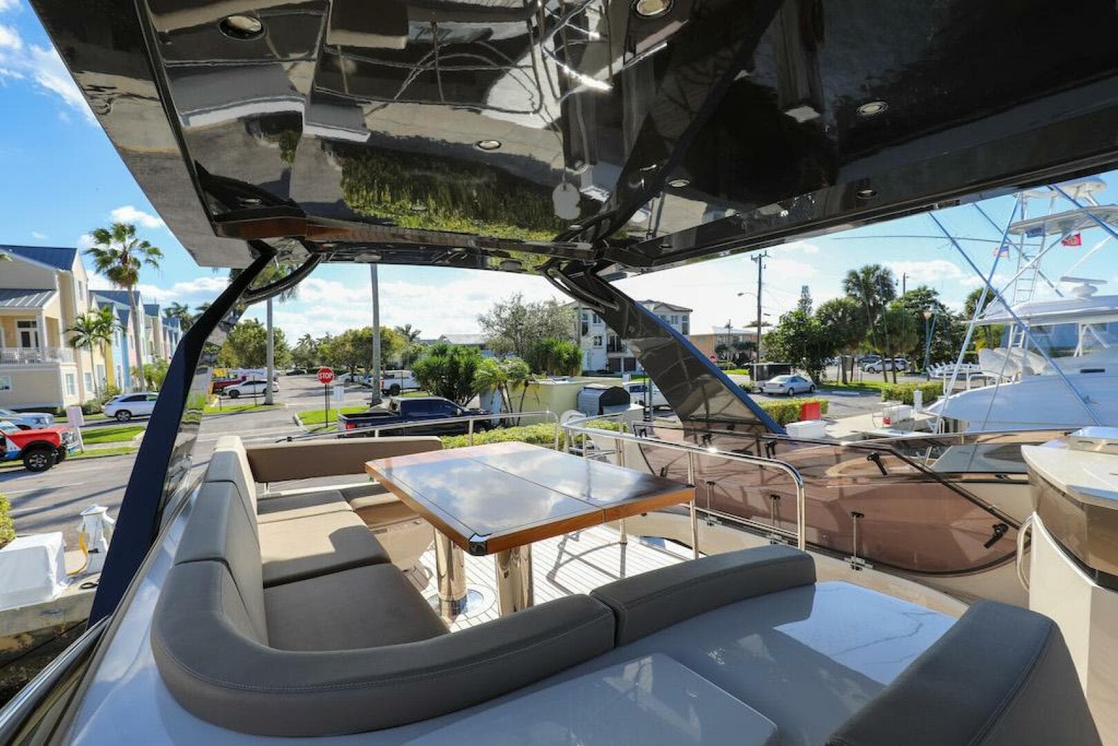 Luxurious 2016 Marquis 660 Sport Yacht with spacious outdoor seating and dining area.