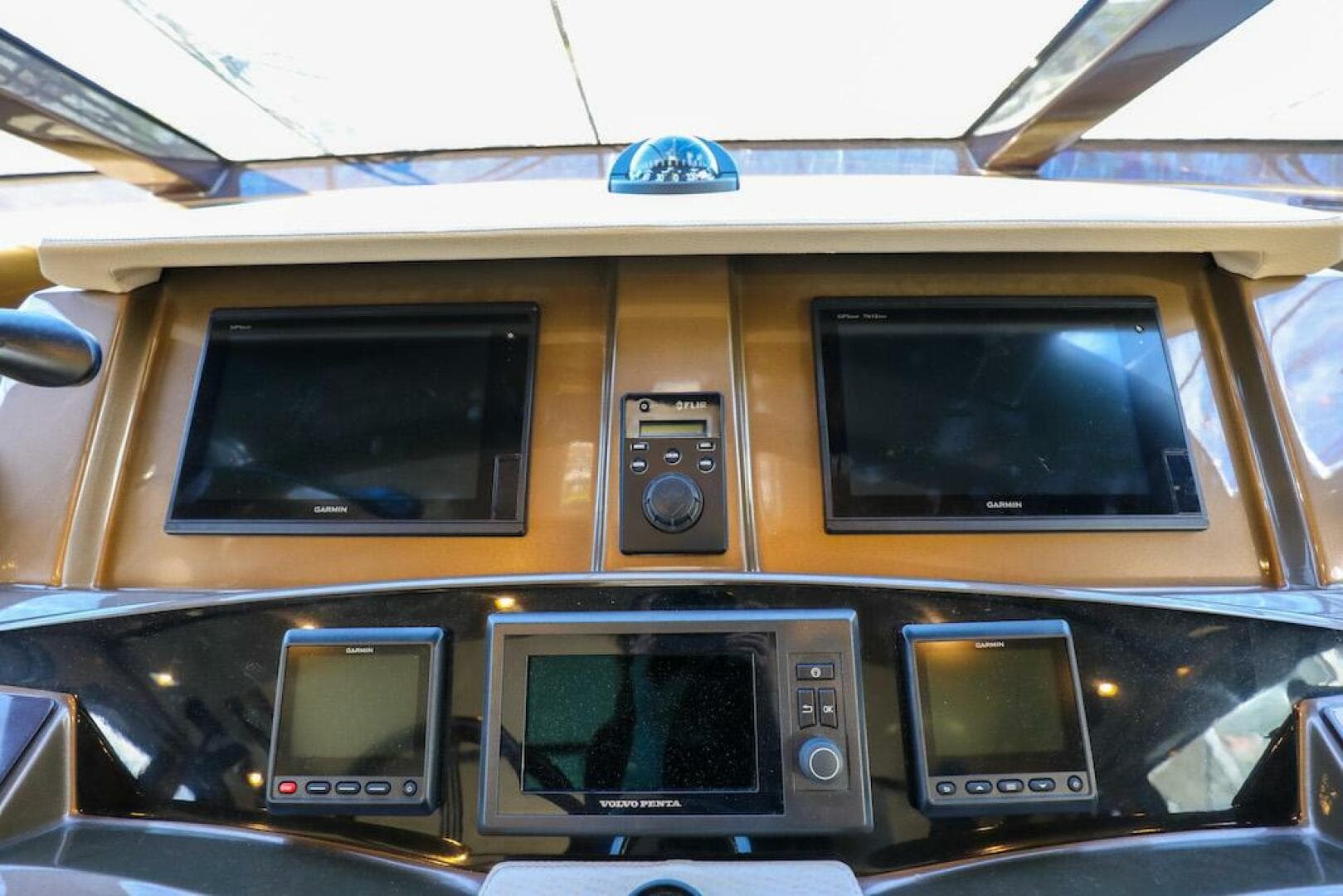 Control panel of 2016 Marquis 660 Sport Yacht with multiple screens and navigation equipment.