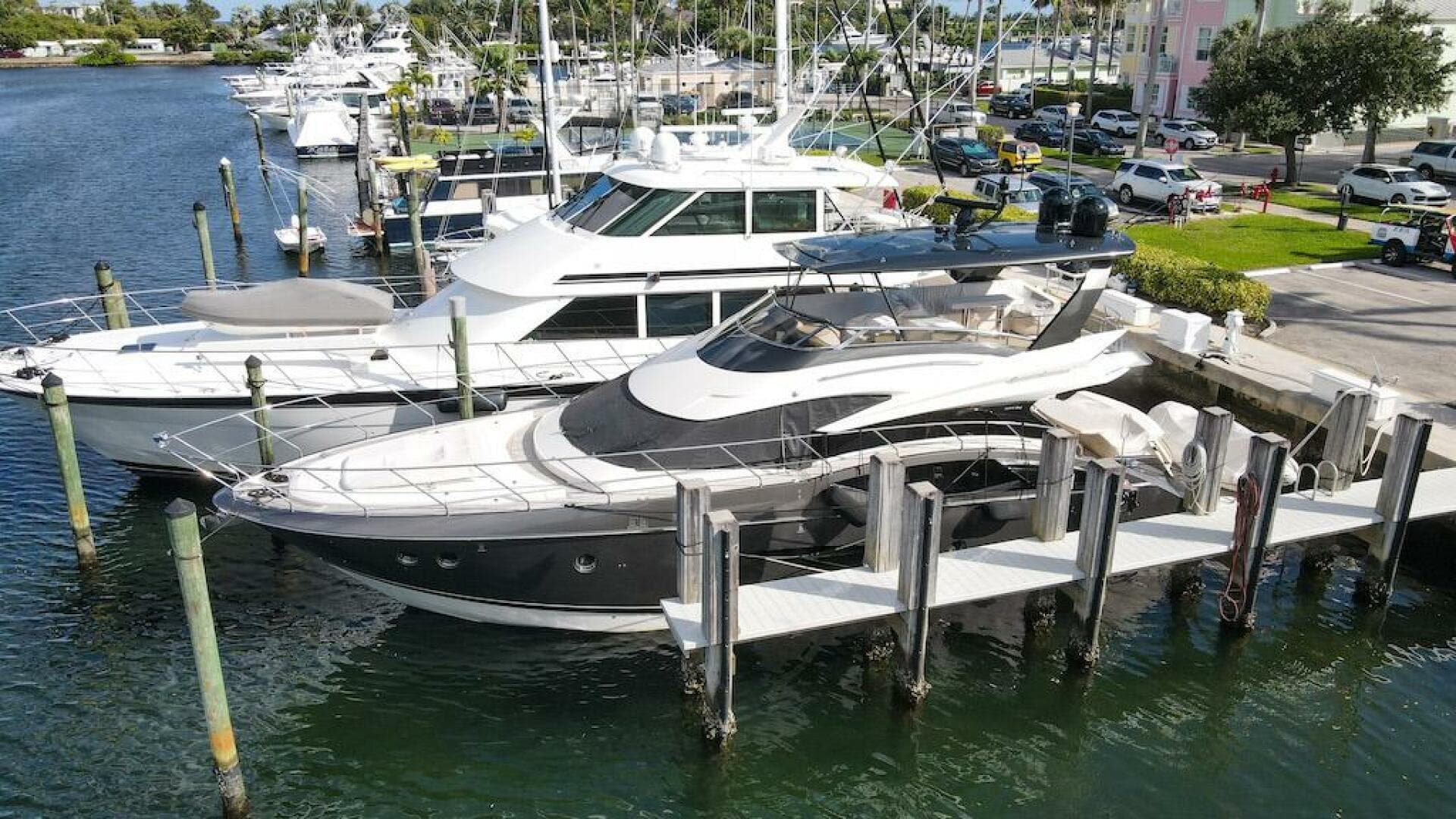 2016 Marquis 660 Sport Yacht docked at marina, surrounded by other boats.