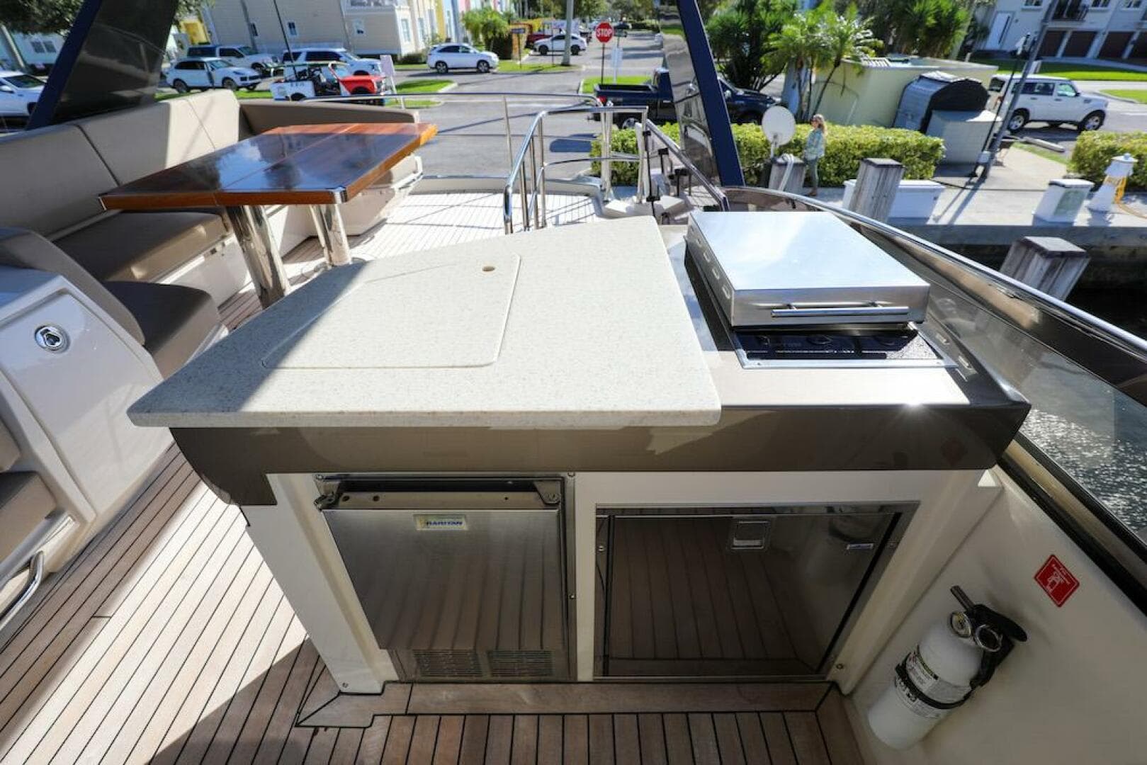 Outdoor kitchen on 2016 Marquis 660 Sport Yacht with grill and seating area.