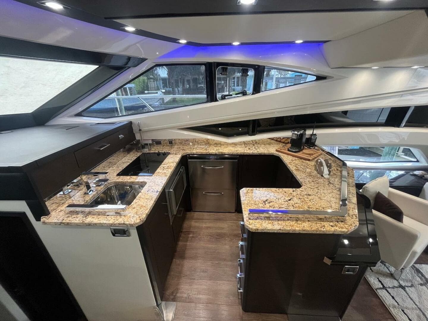 Modern kitchen in 2017 Marquis 500 Sport Yacht with granite countertops and stainless steel appliances.