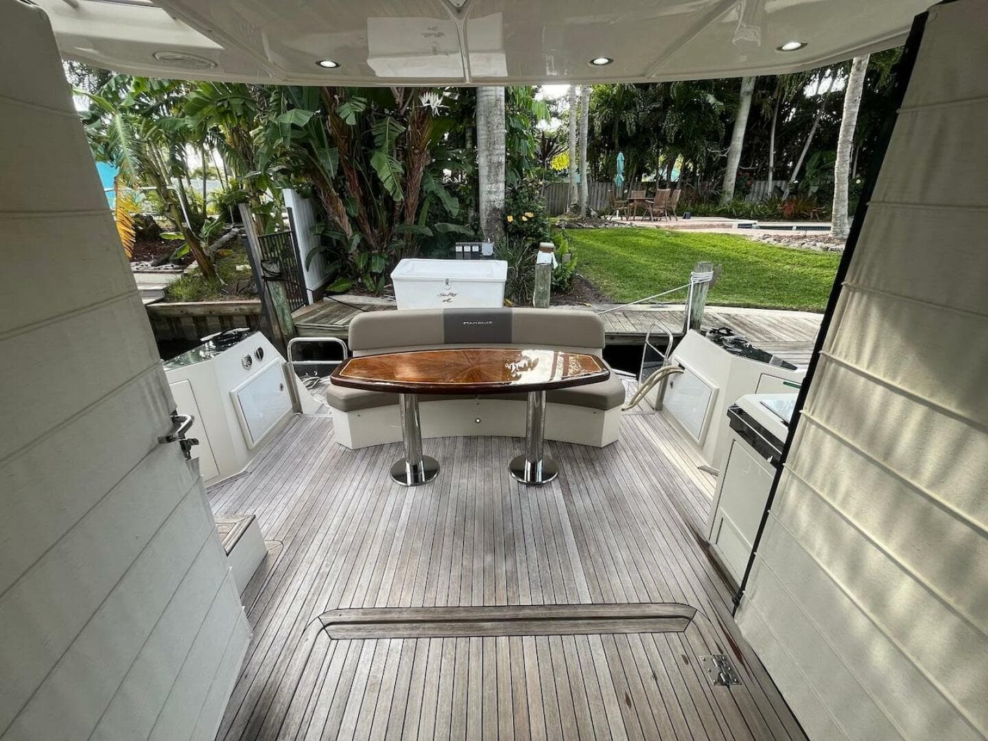 2017 Marquis 500 Sport Yacht deck with wooden table and seating.