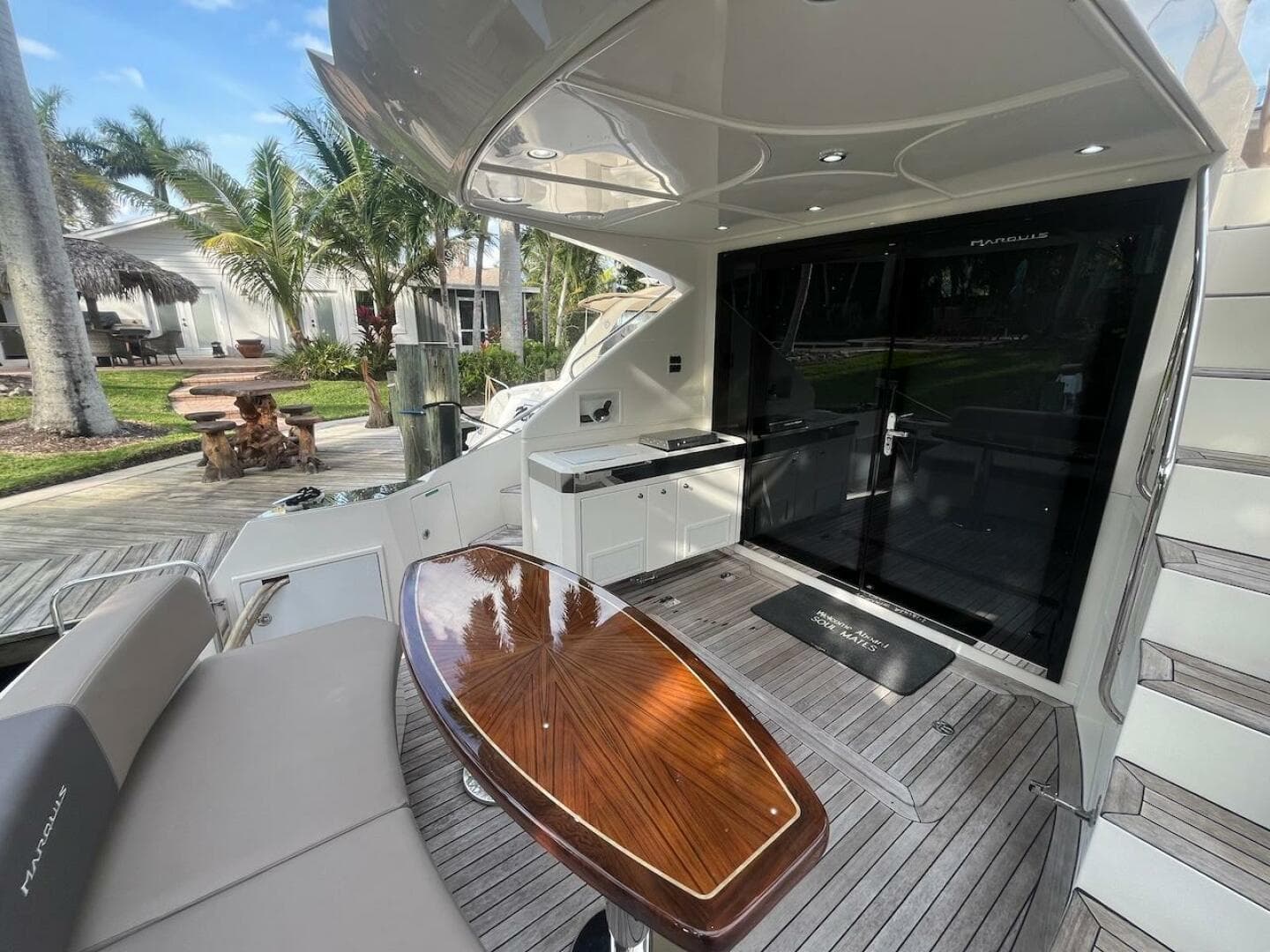 2017 Marquis 500 Sport Yacht deck with seating, table, and outdoor kitchen.