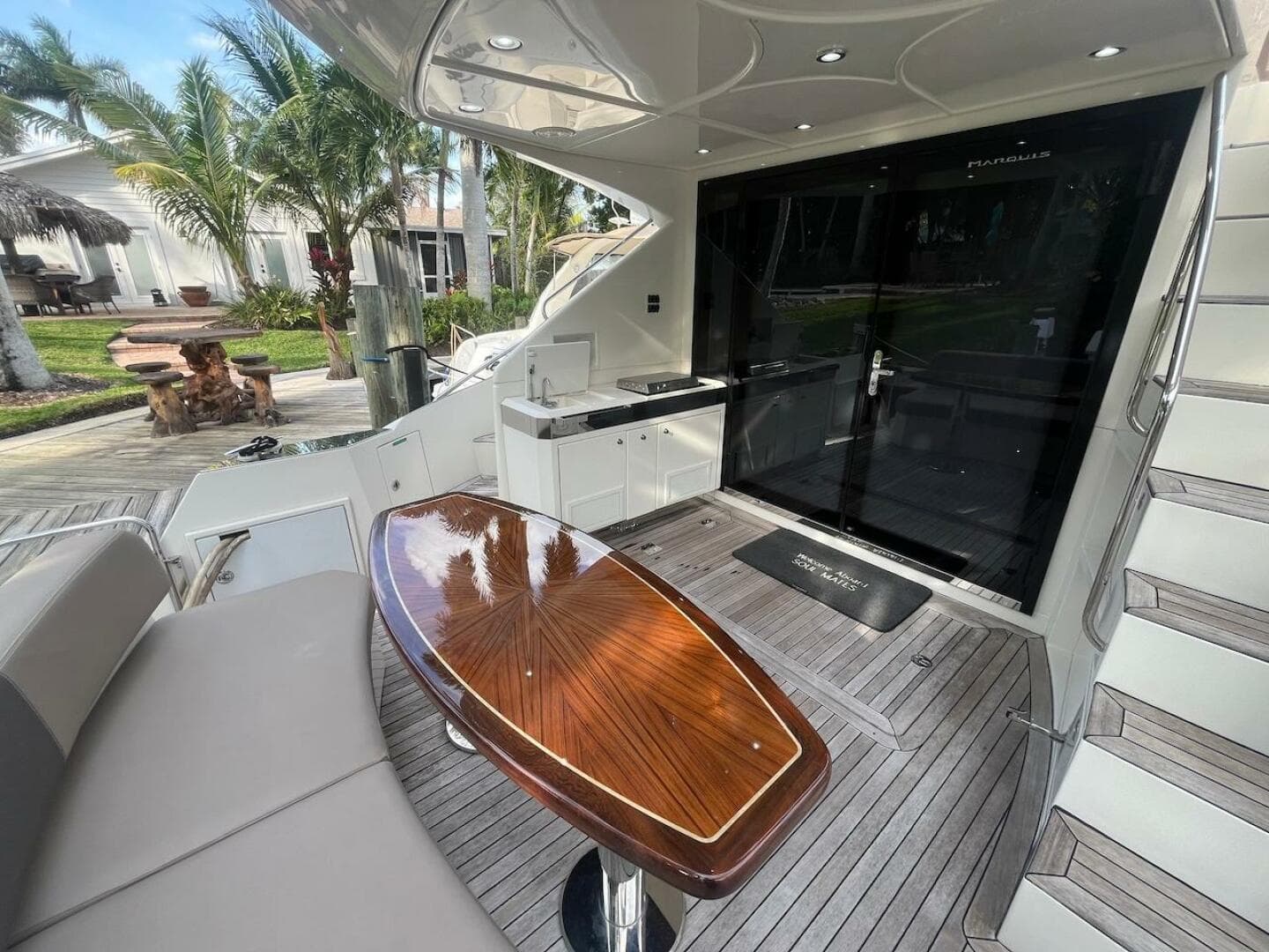2017 Marquis 500 Sport Yacht deck with seating, table, and outdoor kitchen.