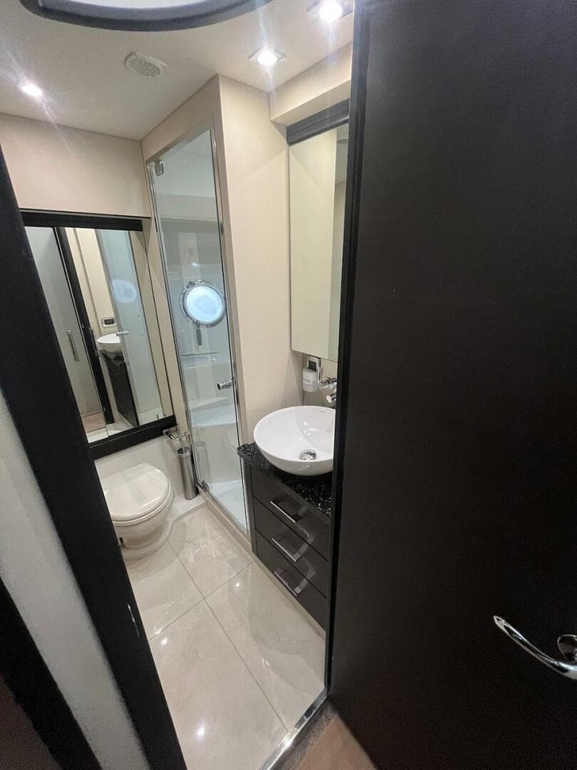 Modern bathroom in 2017 Marquis 500 Sport Yacht with sleek fixtures and ample lighting.